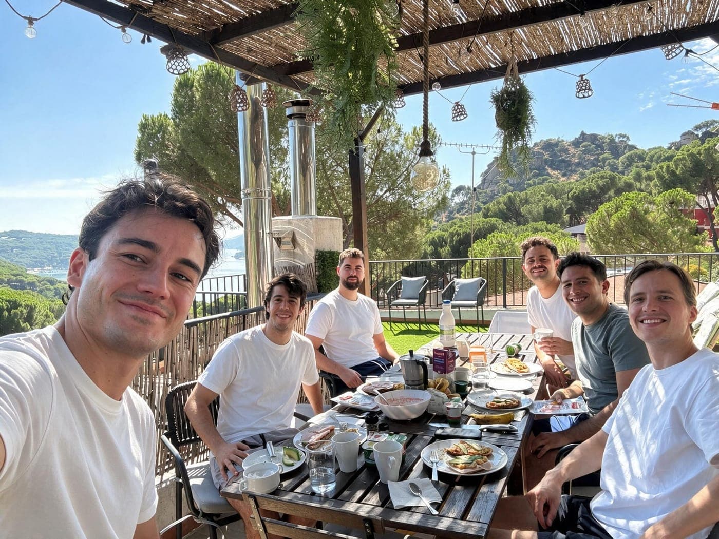 The Traza team having breakfast on a terrace overlooking the sea.