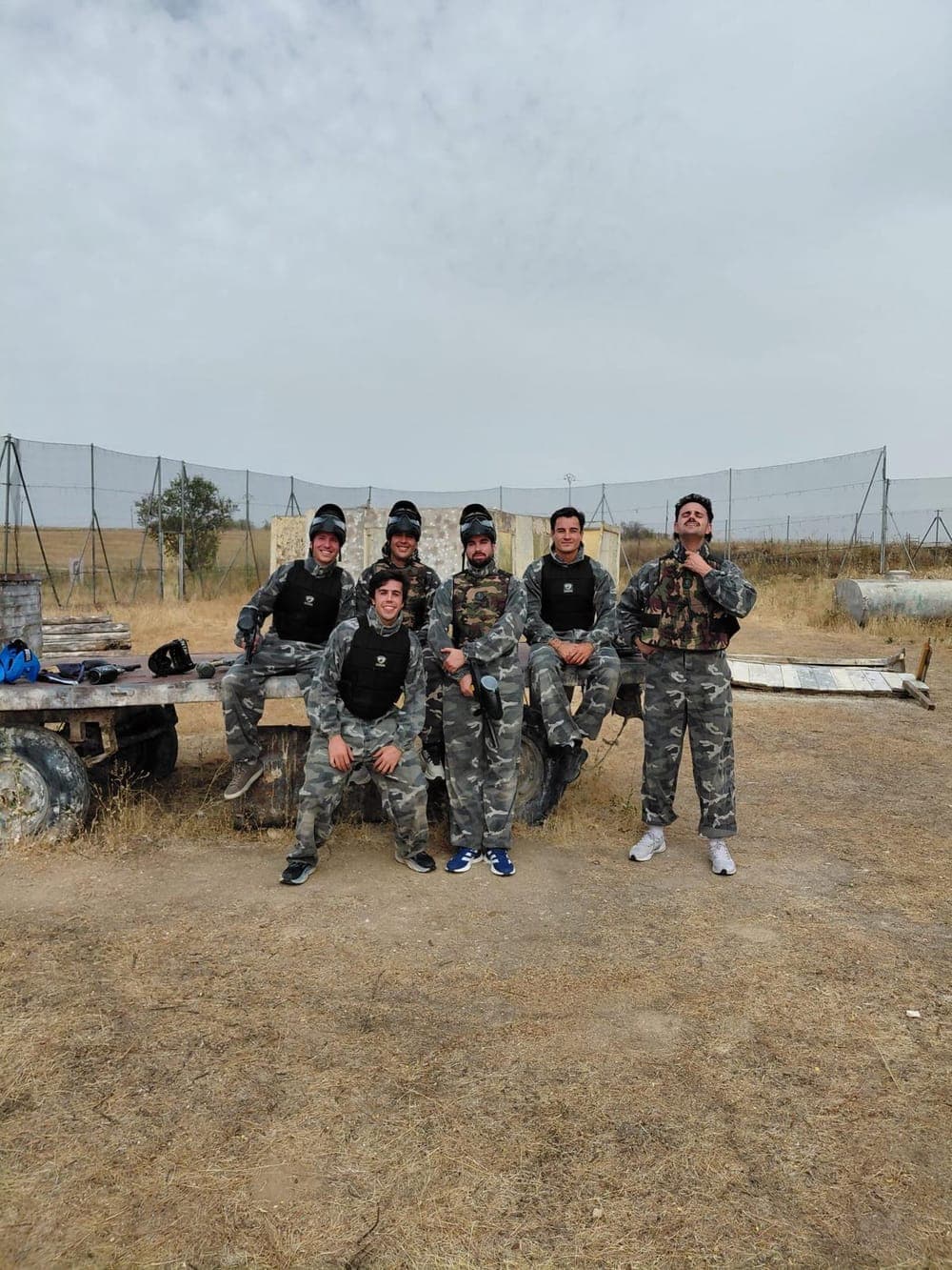 The Traza team in camouflage gear at a paintball field.